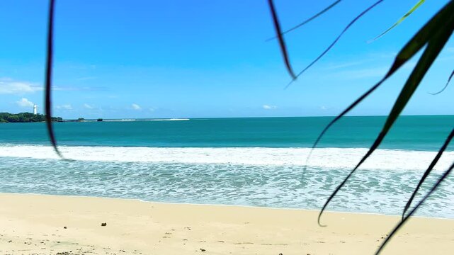 Garut, West Java - Indonesia: May 30, 2026 : A white-sand beach with clear weather and calm waves; a beautiful beach with fine white sand.