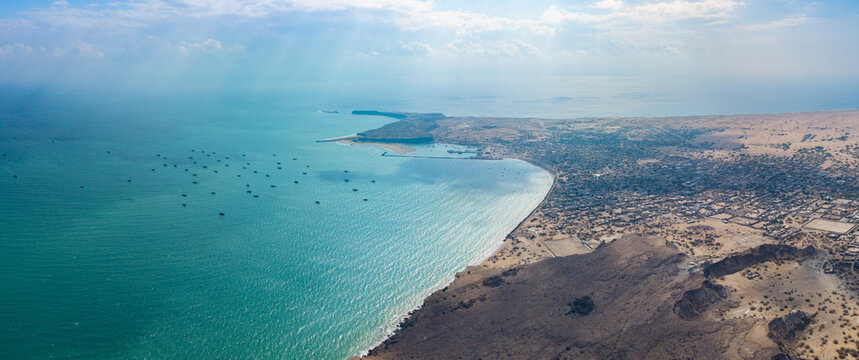 Aerial view of the coastal city of Gwadar with its port, sandy beaches, and arid landscape along the Arabian Sea in Gwadar, Balochistan, Pakistan.