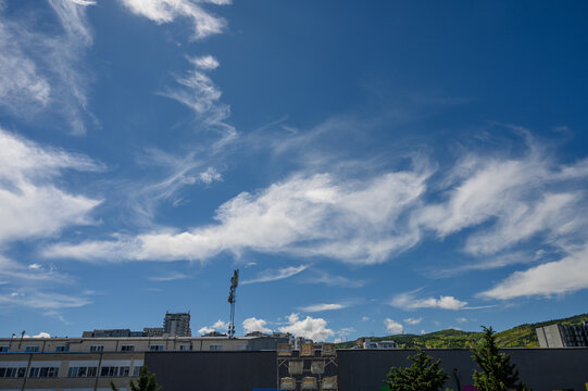 Cirrus Clouds Over Urban Cityscape, Indicating Approaching Warm Front