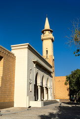Naklejka premium Beautiful traditional architecture of King Abdulaziz Grand Mosque with a minaret under a clear blue sky in the al-Murabba neighborhood of Riyadh, Saudi Arabia