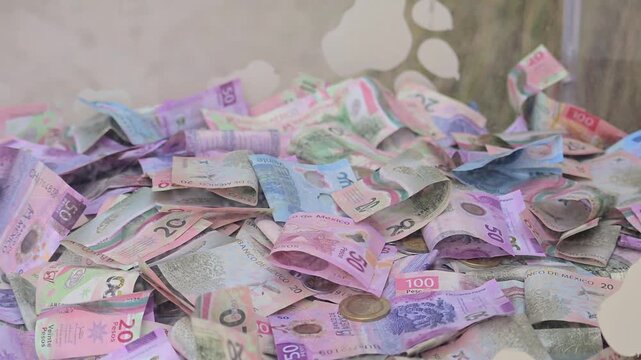 pile of Mexican banknotes of various denominations