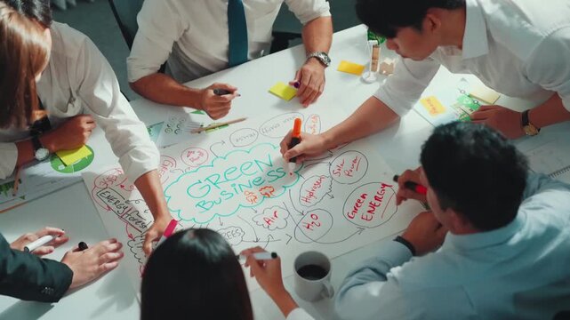 Top view of professional business team working together to brainstorm environmental idea by using mind map. Aerial view of smart manager talking and discussing about sustainable energy. Alimentation.