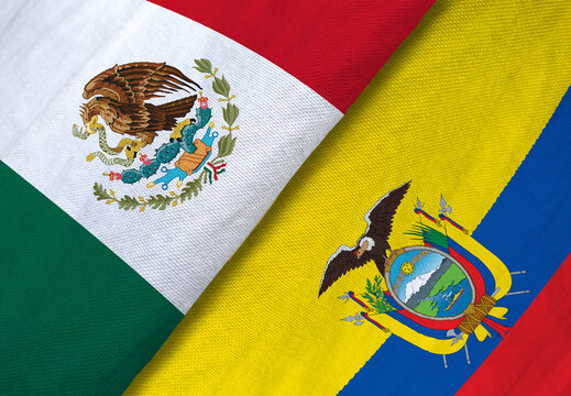 High-angle macro shot of the textile national flags of Mexico and Ecuador overlapping to symbolize sports rivalry or diplomacy.