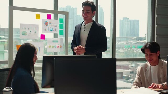 Businessman giving presentation on glass board, manager speaking to diverse team during office meeting, colleagues listening to financial report, coaching and employee leadership development program.