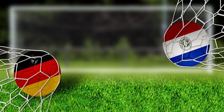 German and Paraguayan soccer balls in goal nets on green field