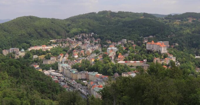 4K locked down stationary motion of breathtaking view of the city buildings and surrounding mountains of the Karlovy Vary area, view from the observation deck of the Diana lookout tower, Karlovy Vary