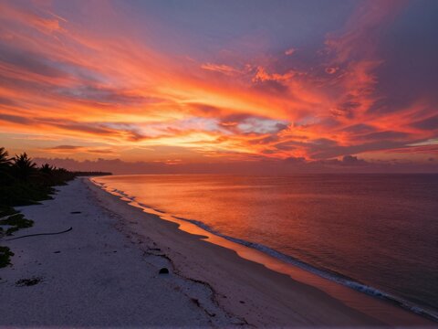 Sunset Fire Clouds over White Sand Beach Aerial