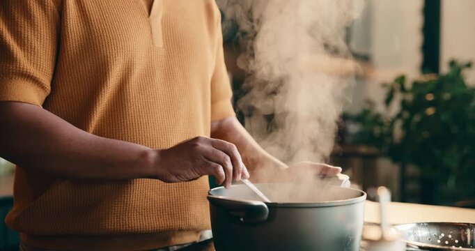 Pot, cooking and hands of man in kitchen at house for meal, dinner or supper with healthy diet. Steam, stir and male person with preparing dish for wellness, nutrition or recipe in apartment.