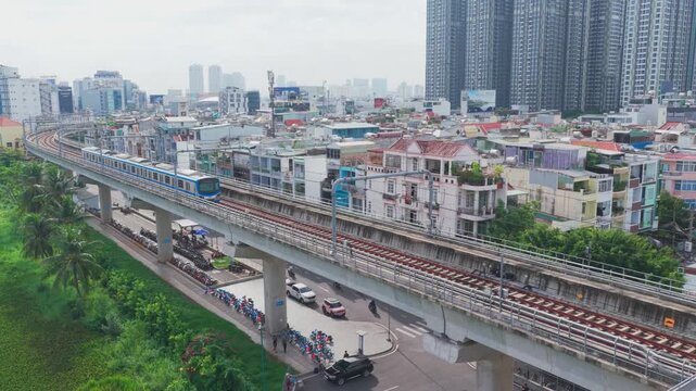 Drone View of Ho Chi Minh City Metro Train Passing Through Elevated Railway in Vietnam