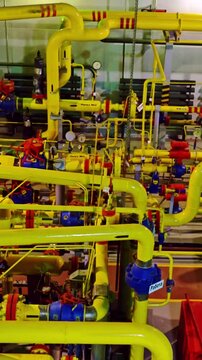 Industrial landscape overview. Factory environment displaying intricate machinery and controls. Wide angle capture of industrial plant illustrating complex valve setups and extensive pipeline networks