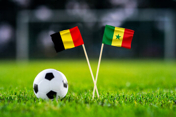 Obraz premium Belgium vs Senegal, national flags before international football tournament Round of 32 match, football on green grass with goal in the background, Seattle, Washington, USA, July 1, 2026