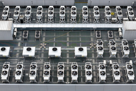 Aerial view of an AI data center rooftop featuring rows of industrial HVAC cooling units and ventilation systems in Warsaw, Masovian Voivodeship, Poland.