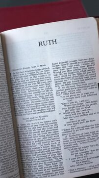 Opening to the Book of Ruth of the Old Testament in the Holy Bible. New Revised Standard Version. Vertical video.