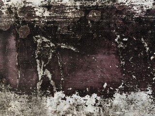 Abstract weathered grunge wall texture with peeling dark paint, rough surface, and distressed patina. Aged background. © suciramadhani