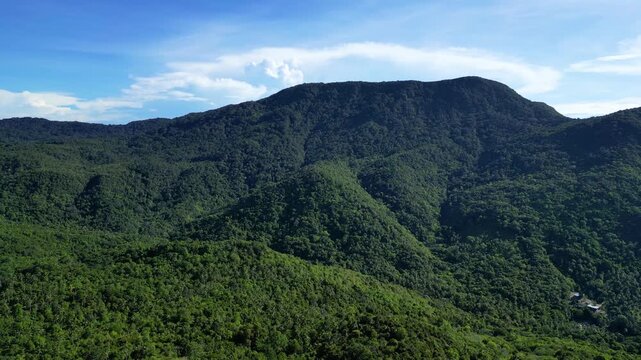 Aerial drone footage featuring a smooth 360-degree orbit around a forested mountain near Thong Nai Pan, Koh Phangan, Surat Thani, Thailand, on Thursday, July 2, 2026. The rotating aerial view showcase