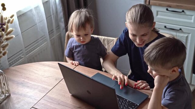 White mother demonstrating laptop to children at rustic kitchen table, small gestures of guidance, light filtering through curtain, symbolic passing of knowledge, hopeful atmosphere, intergenerational