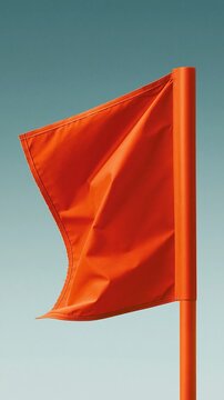 Weathered red warning flag on a pole signifies a coastal hurricane alert against a soft gradient sky background for emergency safety covers
