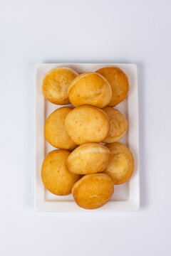 Traditional Kazakh baursak fried dough bread on white plate top view isolated background