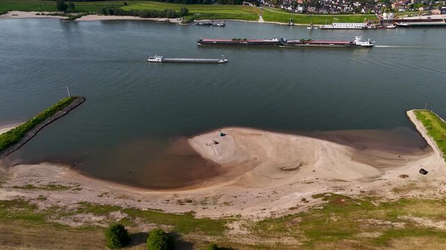 Aerial view of cargo ships navigating a drought-stricken river