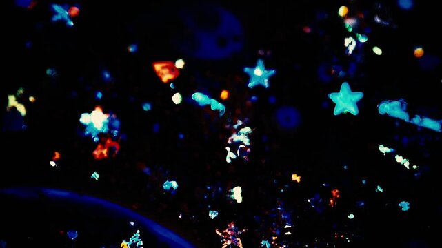Flowing colourful sparkling background on dark 4k video
