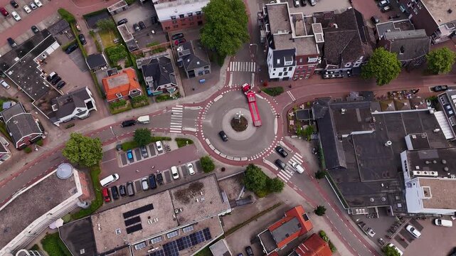 Aerial top-down view of city traffic navigating a roundabout