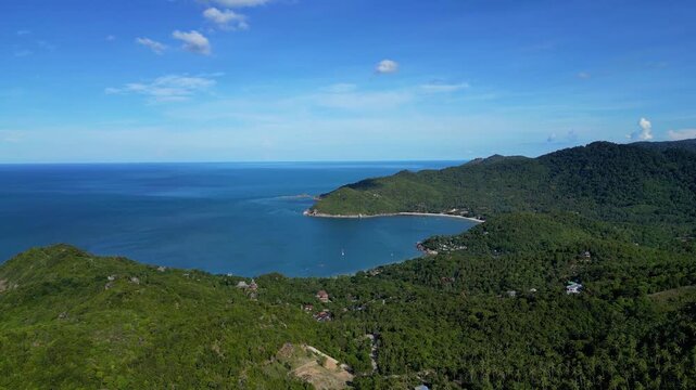 Aerial drone footage of Thong Nai Pan village area in Koh Phangan, Surat Thani, Thailand. The video showcases a scenic combination of tropical mountains, local village surroundings, and the nearby sea