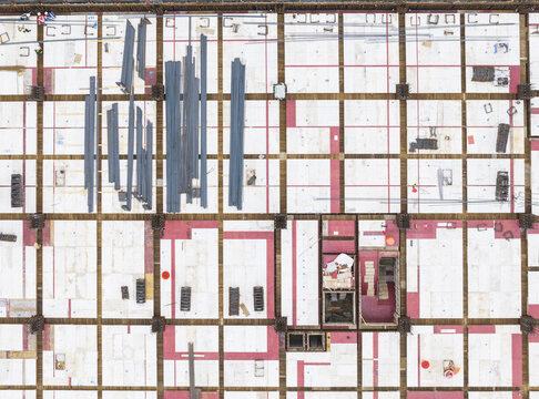 Aerial view of a construction site featuring organized steel rebar bundles and concrete formwork arranged in a grid pattern in Taiwan.