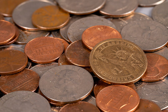 Coins scattered on a surface with different values and sizes