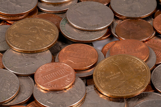 Pile of various coins gathered on a flat surface in a casual setting