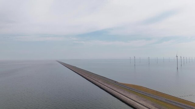 Aerial shot of houtribdijk causeway and offshore wind turbines
