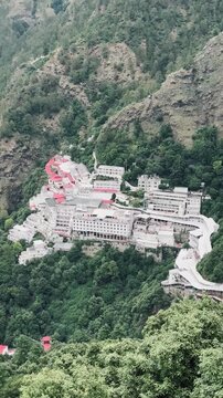 An elevated perspective of the iconic Vaishno Devi Shrine surrounded by lush Himalayan hills, highlighting its magnificent architecture and sacred setting.