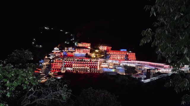 Vaishno Devi Temple beautifully illuminated at night, glowing against the dark Himalayan mountains in Katra, Jammu and Kashmir, India, creating a mesmerizing spiritual atmosphere.