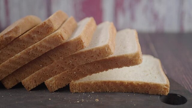 Sliced bread on a wooden board in kitchen setting