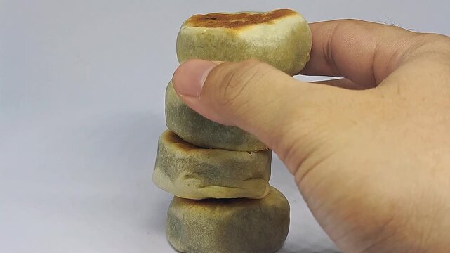 Hand picking bakpia from stack