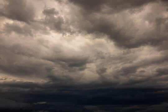 Dramatic Dark Storm Clouds Covering the Sky Before Heavy Rain. Dark, dramatic storm clouds gathering across the sky before heavy rainfall. A powerful weather background featuring dense cloud formation