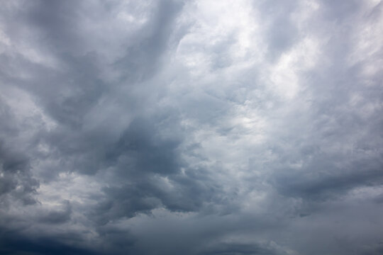 Dramatic Vertical Storm Cloud Formation. An impressive vertical cloud formation rising into the sky with rich gray and blue tones. A striking weather background illustrating dynamic atmospheric 