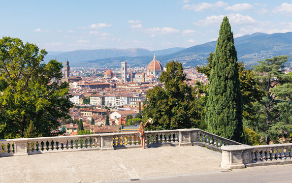 Female tourist looking at Florence cityscape from panoramic terrace in Italy