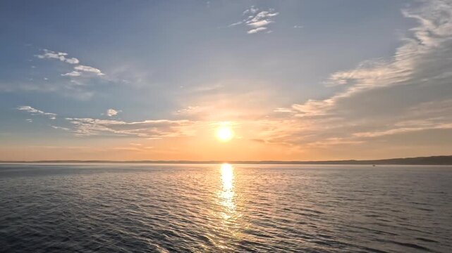 Cinematic fast motion daytime dawn scenery with powerful sunbeams split perfectly over the calm water