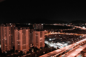 Night city skyline with highway and apartment towers © Wang Dan