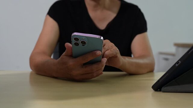 woman email marketing notification concept, Mature woman use smartphone and laptop receive message alert in the mailbox and transfer data at home office.