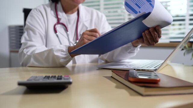 Doctor working in hospital use calculator, Healthcare and medical concept.