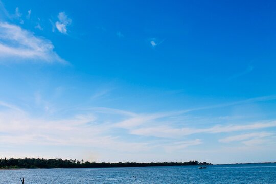 Peaceful blue sea and wide horizon at Tanjung Lesung Beach, Banten, Indonesia. Eye-level view with sharp focus and open copy space, ideal for travel, nature, wellness and coastal themes.