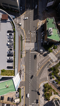 Busan, Busan, South Korea - 26 June 2026: Aerial view of a busy urban intersection with cars parked in rows, pedestrian crossings, and surrounding buildings.