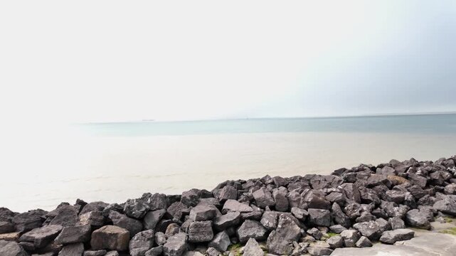 Boulogne-sur-Mer, June 2026 - Hike along the Opal Coast in northern France - View of the harbor and the seawall, with calm waters and a soothing mist