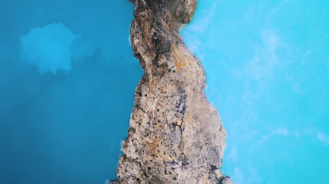 Drone Shot Over Majestic Indonesian Ridge Dividing Deep Azure Water and Bright Teal Lake. Aerial Amazing Natural Landscape Photography Highlighting Rare Sulfur Acid Geological Formations Footage 4k