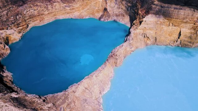 High Drone Angle View of Two Different Colored Volcanic Caldera Basins. Aerial Shot of Beautiful Indonesian Landmark in Wilderness Surrounded by High Mountain Cliff Walls at Daytime 4k