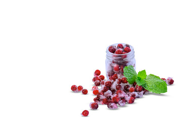 Frozen red currants with ice crystals in a glass jar isolated on white background. Ripe frozen berries with mint leaf and copy space. © Светлана Кушнир