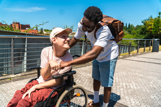 Diverse friends connecting bumping fists in park