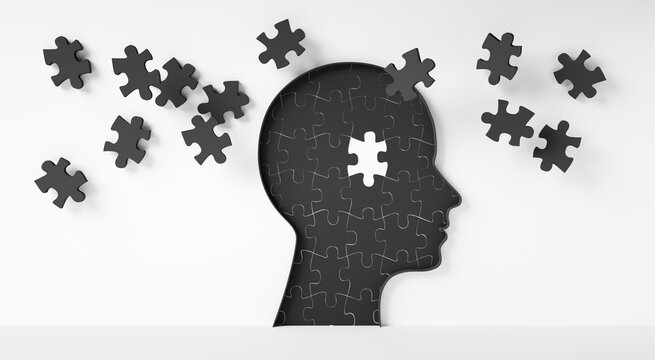 Conceptual artwork showing a 3D silhouette of a head surrounded by group of puzzle pieces, symbolizing mental input, activity, intelligence, or creativity on white background