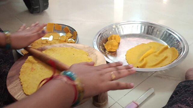 Close up of Hands Rolling Out Dough for Traditional Gujarati Dhokli Snack
